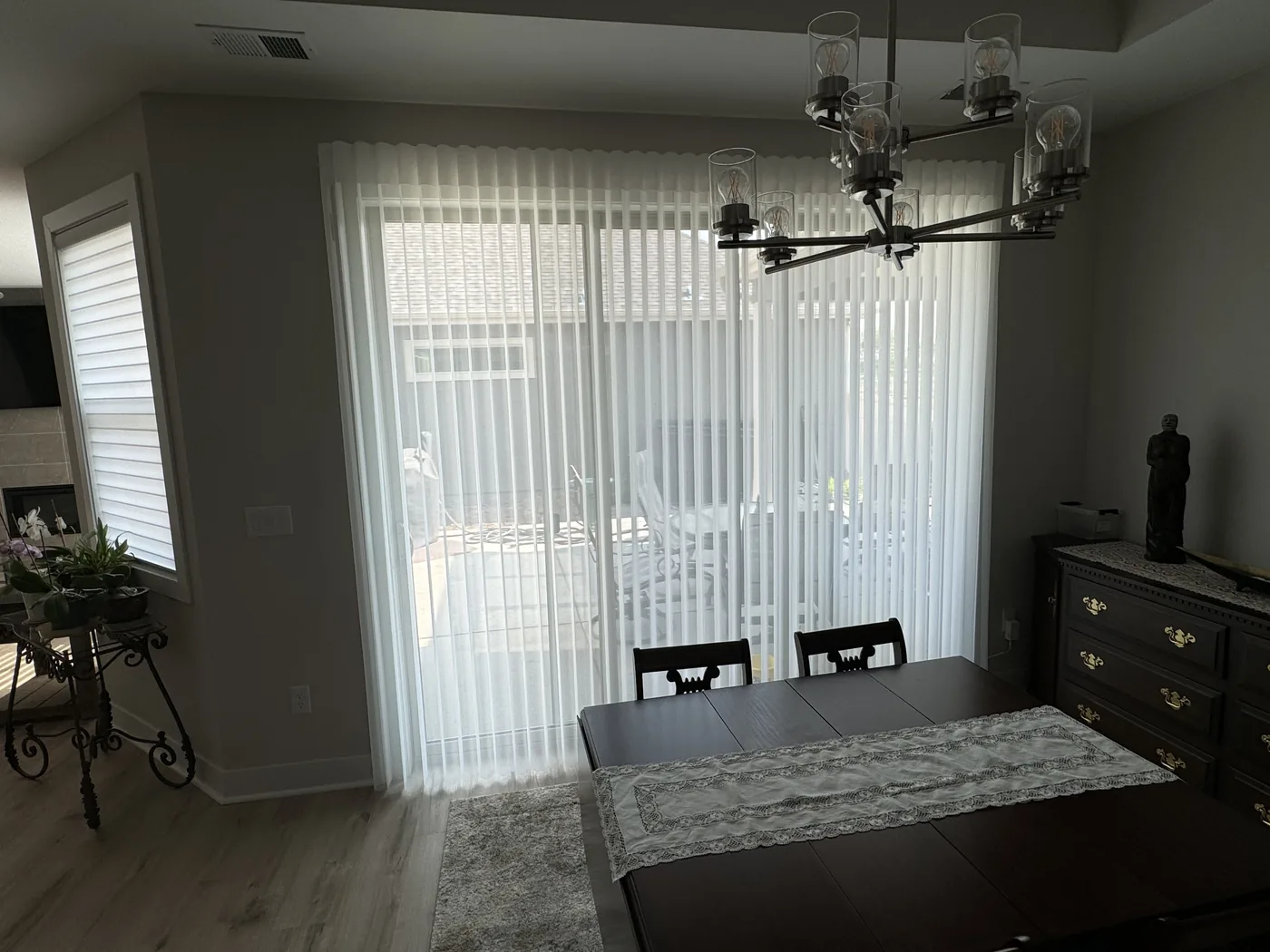 Layered window coverings in a Boulder master bedroom, custom installation by Howard's Draperies