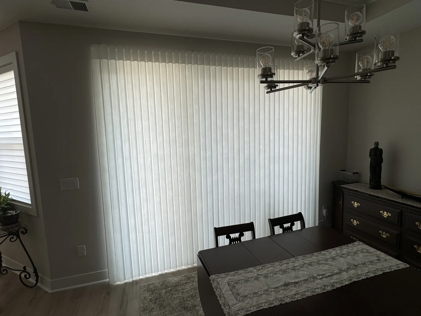 Custom shades and drapery in a bright Boulder bedroom, Howard's Draperies window treatment installation